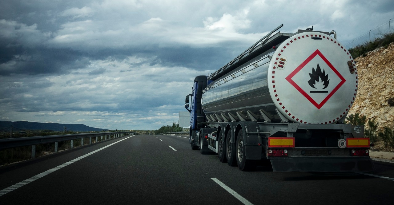 Tanker trucks on the road with the sign of inflammable material.